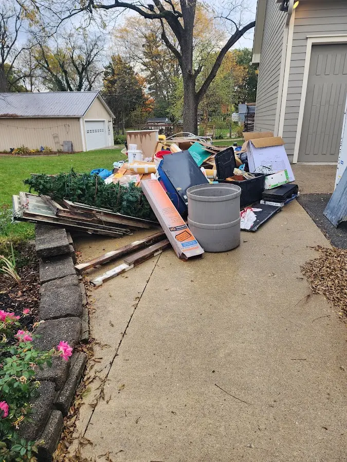 Dumpster being loaded with debris for 10 Yard Dumpster Rental in Manchester-by-the-Sea